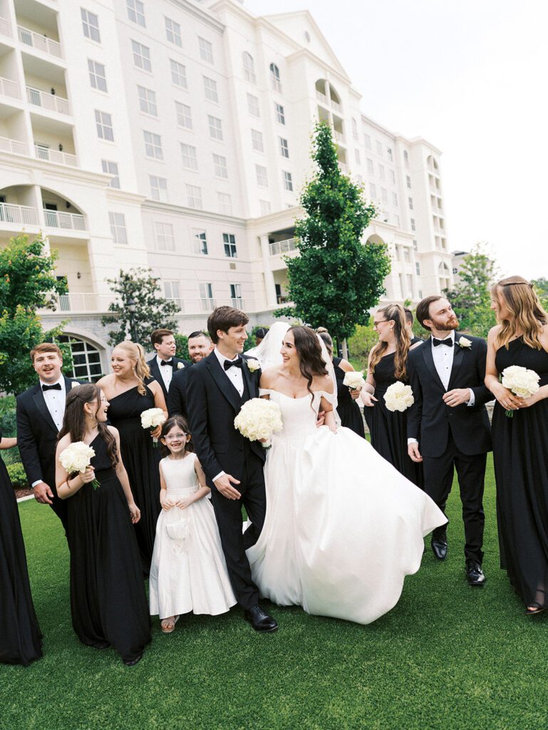 Couple and their wedding party walking at the Ballantyne Hotel in Charlotte, NC