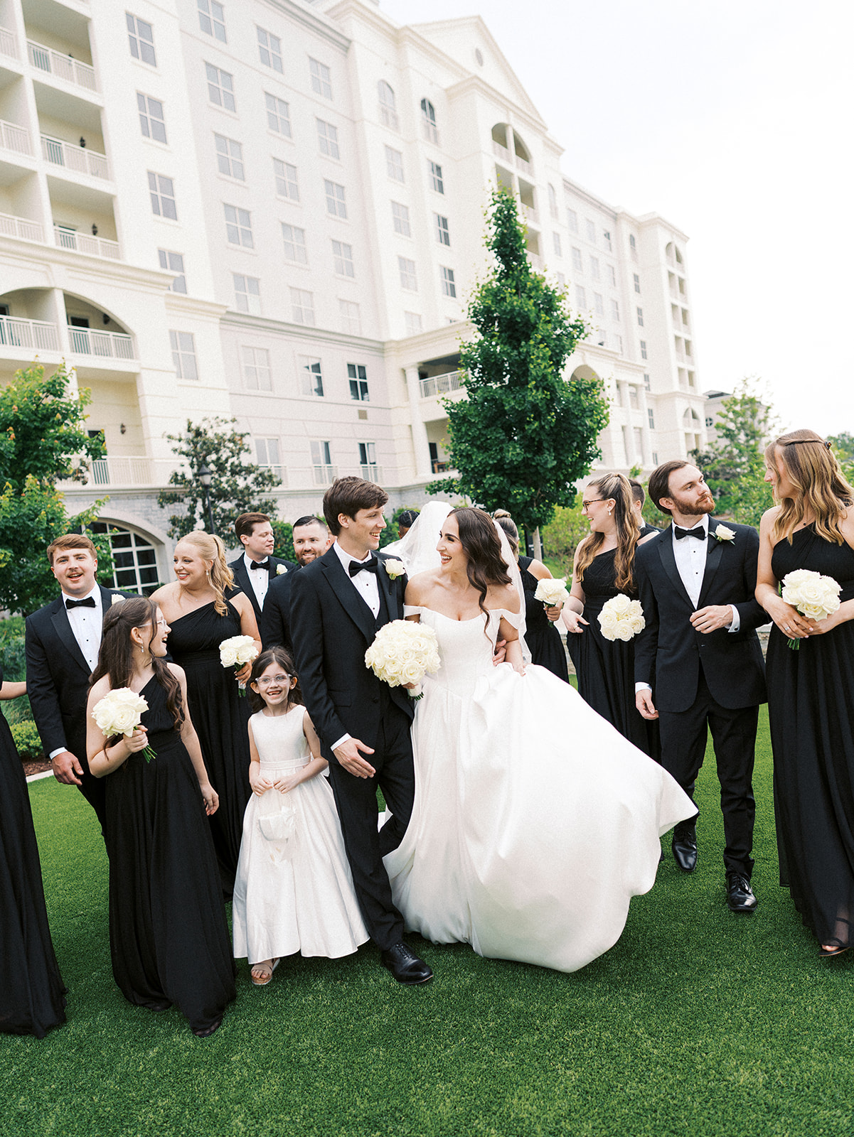 Couple and their wedding party walking at the Ballantyne Hotel in Charlotte, NC